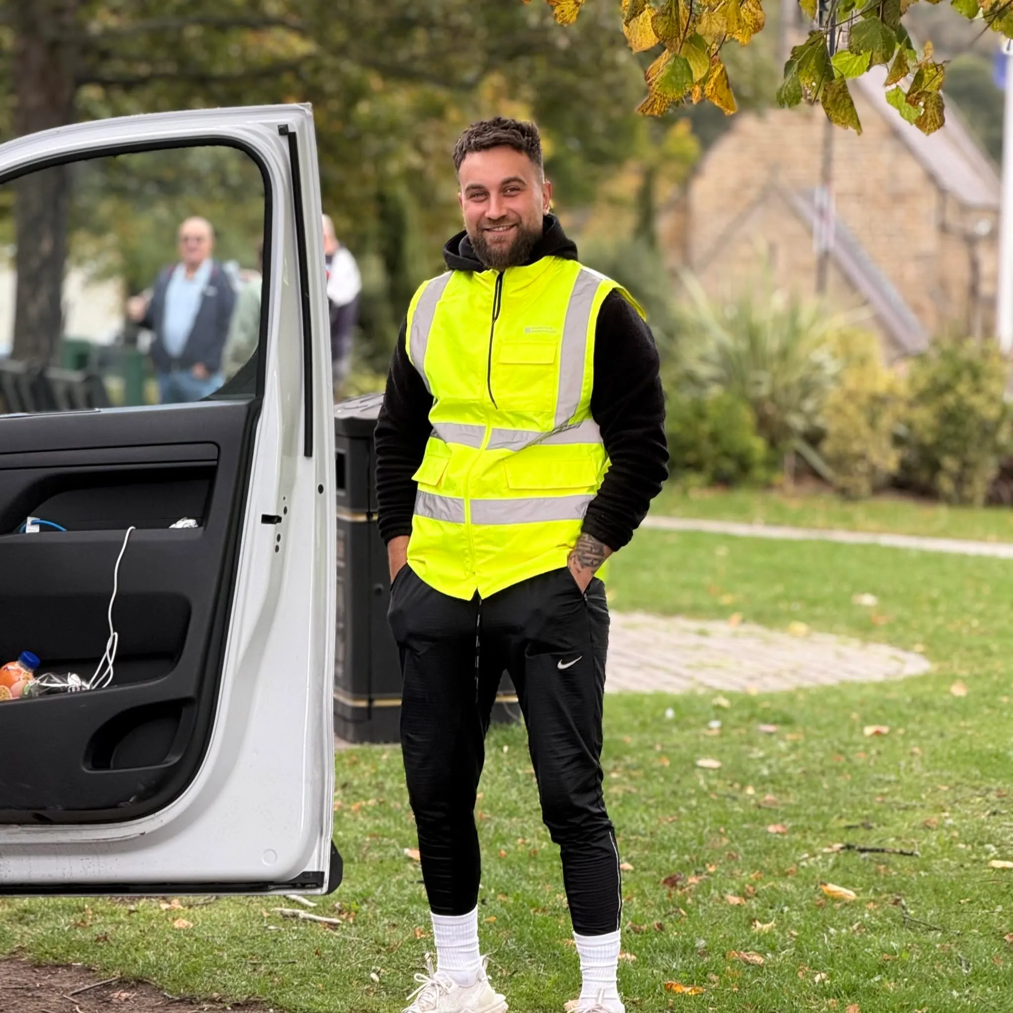 Angel, standing beside his work van