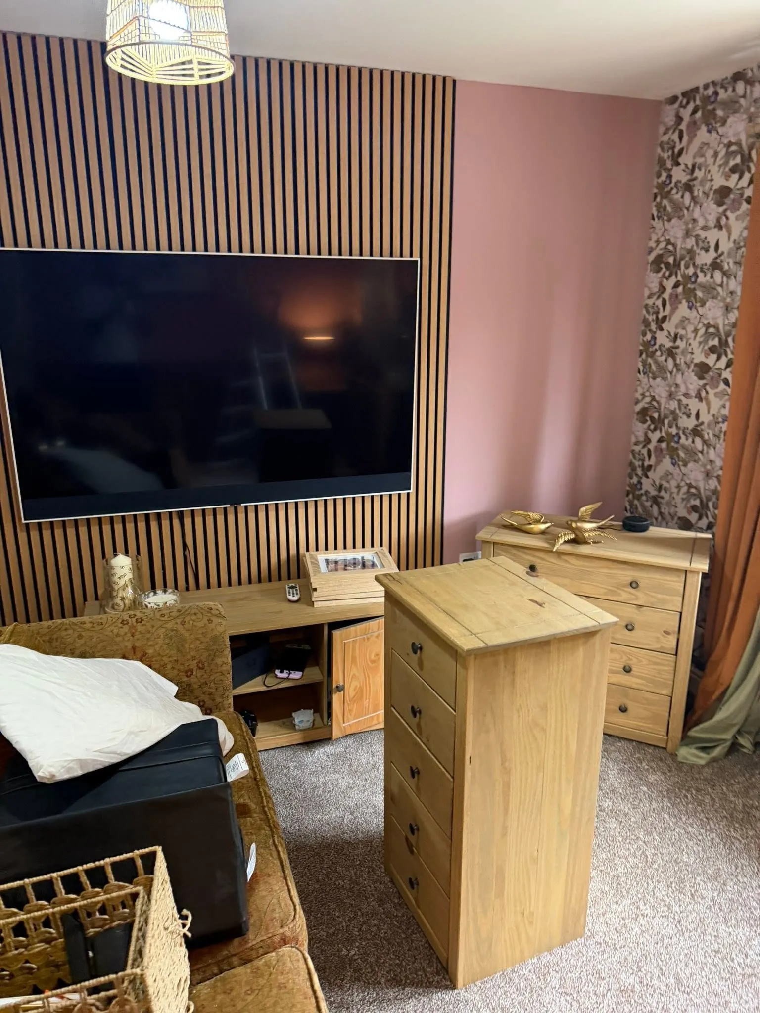 A living room with a fitted oak slat feature wall and freshly decorated walls — a recent job